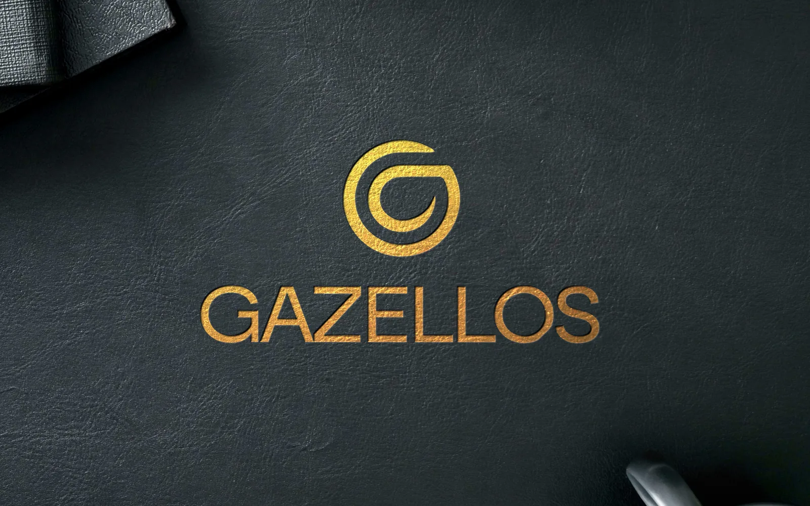 Gazellos logo in gold on a dark textured surface
