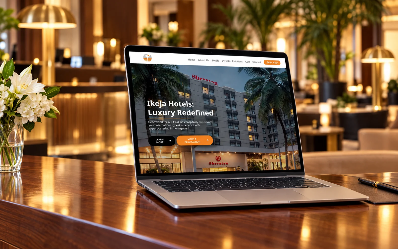 Ikeja Hotels brand identity and website by Mike Bruce Design, shown on a laptop in a hotel lobby